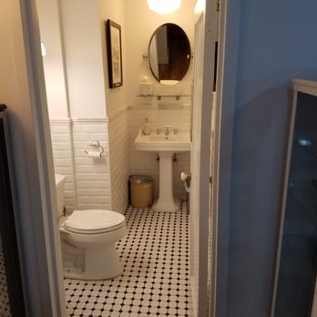 Natan Schleider MD - Patient bathroom at office of Natan Schleider MD fully restored with subwat tile and marble fringe walls, mosaic floor, 1920s pedestal sink - Family Practice Near Me - New York, New York Natan Schleider MD - Patient bathroom at office of Natan Schleider MD fully restored with subwat tile and marble fringe walls, mosaic floor, 1920s pedestal sink - Family Practice Near Me - New York, New York
