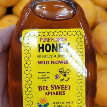 Yellow Banks Groves - a hand holding a jar of honey - Fruits & Veggies Near Me - Largo, Florida Yellow Banks Groves - a hand holding a jar of honey - Fruits & Veggies Near Me - Largo, Florida