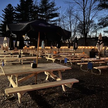 The Woodshed - a picnic area with tables and umbrellas - American Near Me - Manchester, Maine The Woodshed - a picnic area with tables and umbrellas - American Near Me - Manchester, Maine