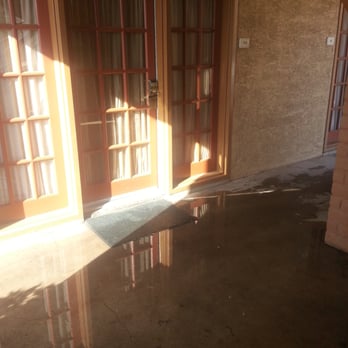 MCM Elegante Suites - This is the puddle we had to walk through to get into or out of our room. - Hotels Near Me - Abilene, Texas