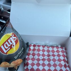 Front Porch Cakery & Deli - Sandwich box packed neatly for travel/to-go. Sandwich in a wrapper, chips individually bagged, and the pickle wrapped in aluminum foil.