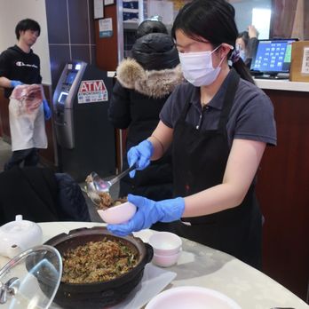 Dong Kee - Our server preparing the eel clay pot rice servings. - Chinese Near Me - Scarborough, Ontario