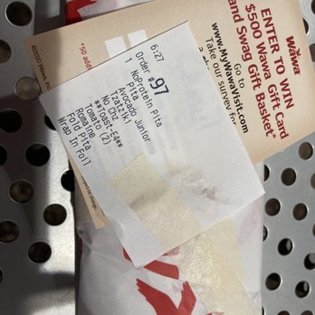 Wawa - a packet of food sitting on a metal grate - Gas Stations Near Me - Land O' Lakes, Florida Wawa - a packet of food sitting on a metal grate - Gas Stations Near Me - Land O' Lakes, Florida
