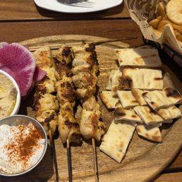 Chicken skewers and fries. Chicken skewers and fries.