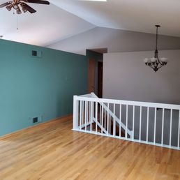 an empty room with a ceiling fan