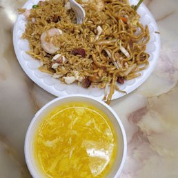 a plate of noodles and a bowl of soup