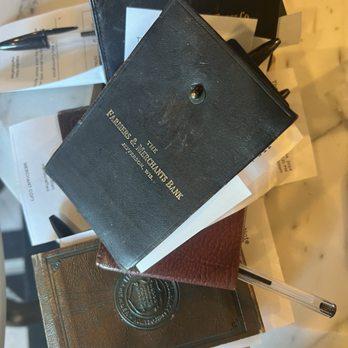 The Note - Look how cute these old check books are! - Several old checkbooks and pens are arranged on a marble surface, with some papers and receipts visible. - Cocktail Bars Near Me - Lexington, Ohio