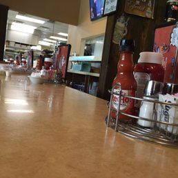 a counter with condiments and condiments a counter with condiments and condiments