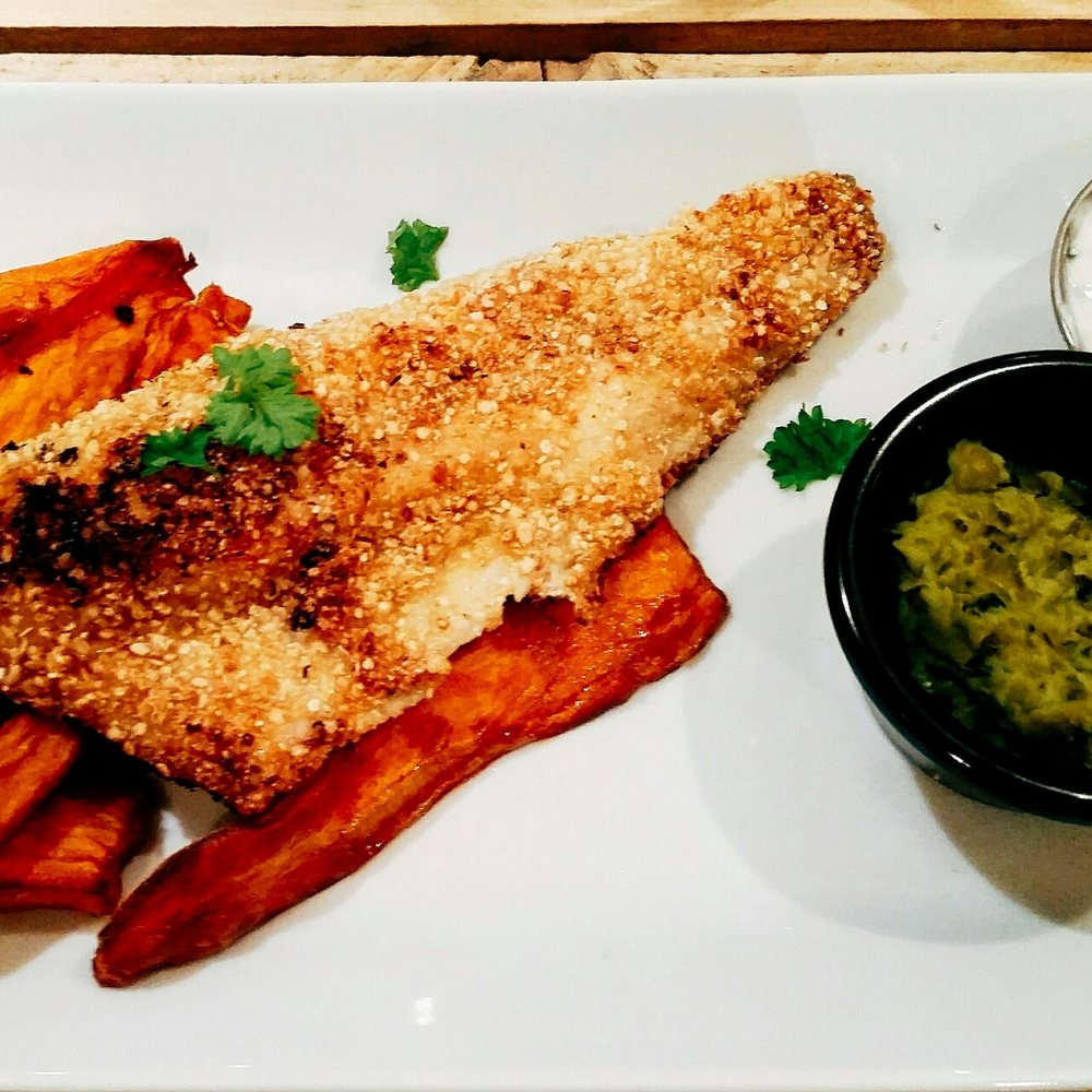 KCal Kitchen - Sea bass coated in a quinoa crumb served with sweet potato fries, mushy peas and tartar sauce on the side. - Juice Bars & Smoothies Near Me - Glasgow, GLG