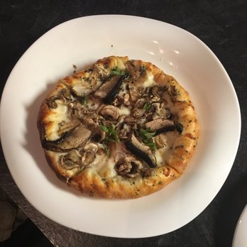 Marinades Pizza Bistro - a mushroom pizza on a white plate - Pizza Near Me - Rockford, Michigan Marinades Pizza Bistro - a mushroom pizza on a white plate - Pizza Near Me - Rockford, Michigan