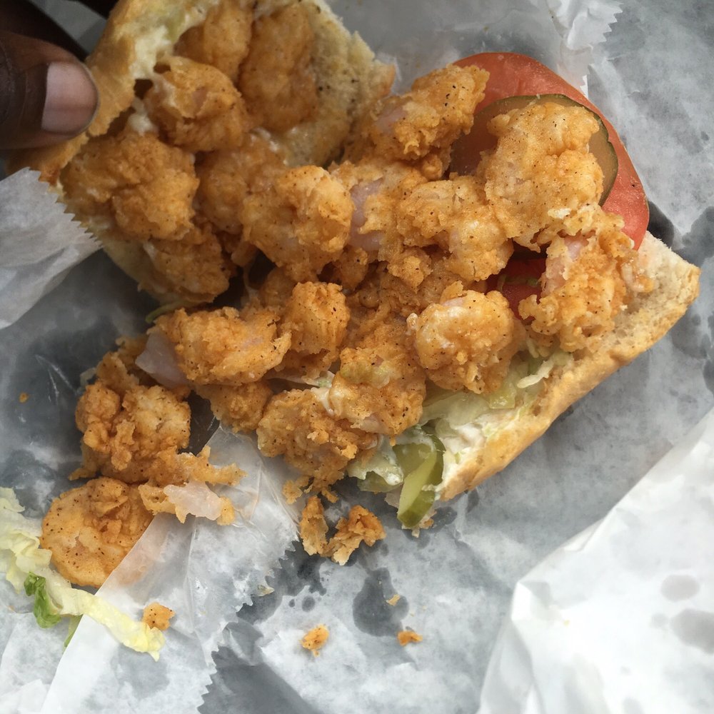 Quickway Po-Boys - a hand holding a piece of fried chicken sandwich - Sandwiches Near Me - Amite, Louisiana Quickway Po-Boys - a hand holding a piece of fried chicken sandwich - Sandwiches Near Me - Amite, Louisiana