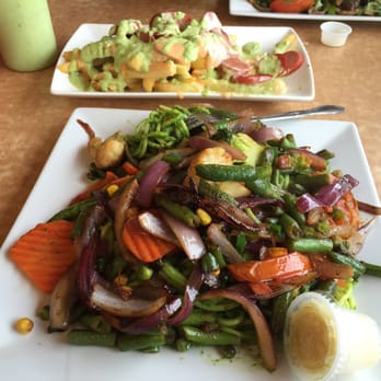 El Pollo Imperial - Tallarines verdes with sautéed veggies and salchipapas in the back - Peruvian Near Me - Long Beach, California El Pollo Imperial - Tallarines verdes with sautéed veggies and salchipapas in the back - Peruvian Near Me - Long Beach, California