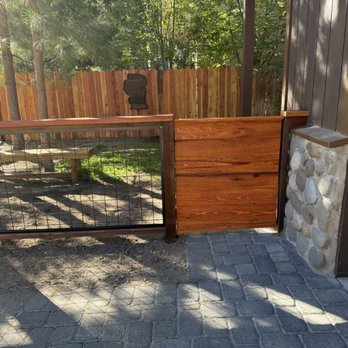 Noll Construction Solutions - Added height to the shared fence line, built a redwood gate, and enclosed the remainder of the yard with hog wire fencing. - General Contractors Near Me Noll Construction Solutions - Added height to the shared fence line, built a redwood gate, and enclosed the remainder of the yard with hog wire fencing. - General Contractors Near Me