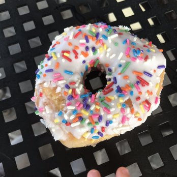 City Donut - Glazed with white icing and sprinkles. Already licked by my toddler - Donuts Near Me - Orange Beach, Alabama