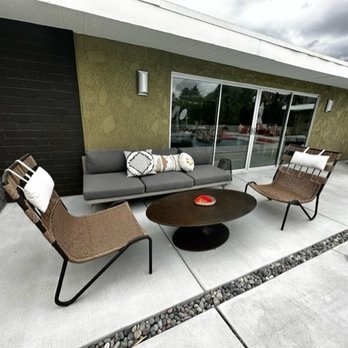 Bigg Palm Springs - Poolside seating area, one of many outdoor lounge areas - Vacation Rentals Near Me - Palm Springs, California