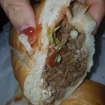 Bella Italian Eatery - a hand holding a sandwich - Pizza Near Me - Groveville, New Jersey