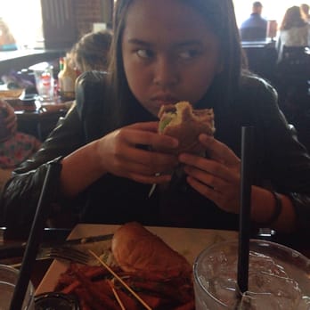 Nicky Rottens - My daughter not appreciating her picture being taken. Lol. That is her BBQ burger with sweet potato fries. - Sports Bars Near Me - Coronado, California
