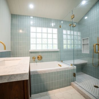 Ground Up Builders - Custom bathroom remodel. Built in tub,  frameless glass enclosure, marble counters, "bottle" glass blocks for natural light, brass hardware. - General Contractors Near Me