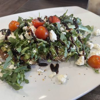 Broken Yolk Cafe - Feta Avocado Toast- there is a ton of avocado under there! - Breakfast & Brunch Near Me - Fullerton, California Broken Yolk Cafe - Feta Avocado Toast- there is a ton of avocado under there! - Breakfast & Brunch Near Me - Fullerton, California