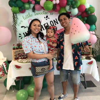 Cloud Food Creations - a man and a woman holding a baby in front of a watermelon backdrop - Candy Stores Near Me - Los Angeles, California
