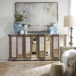 A & M Home Furnishings - A beautiful credenza from Hooker Furniture combines a mirrored front & gold accents.  Interesting great shape.