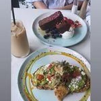 Bluestone Lane Hoboken Café - Front to back: Avocado smash with spicy plant chicken, iced latte (left), and banana bread with ricotta cheese & berries - Coffee & Tea Near Me - Hoboken, New Jersey