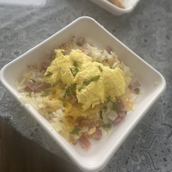Snooze, an A.M. Eatery - Spud Deluxe, hash browns, cheese and scallions (green onions); topped with scrambled eggs, ham and onions. - Breakfast & Brunch Near Me - Nashville, Tennessee