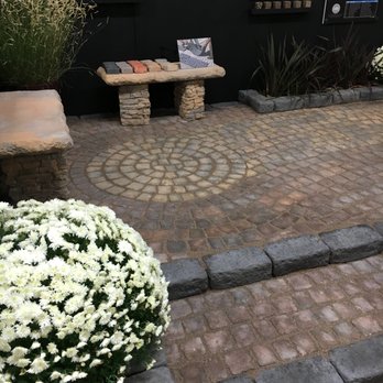 ABQ Home & Remodeling Show - a brick patio with a bench and flowers - General Contractors Near Me - Albuquerque, New Mexico ABQ Home & Remodeling Show - a brick patio with a bench and flowers - General Contractors Near Me - Albuquerque, New Mexico
