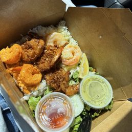Sampler with coco shrimp, garlic butter shrimp, and spicy shrimp. Sampler with coco shrimp, garlic butter shrimp, and spicy shrimp.