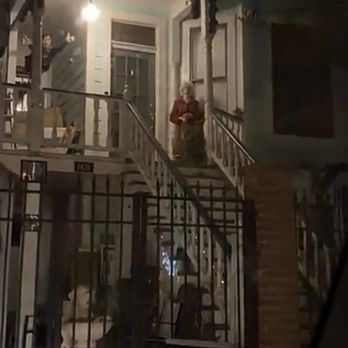 Dorothea Puente's House - Video screenshot of the front of the home with fake person in front and the Superman in the back - Landmarks & Historical Buildings Near Me - Sacramento, California