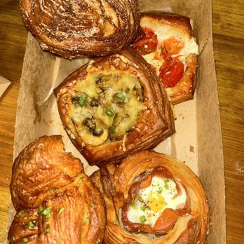 Moonbelly Bakery - Top left: cinnamon bun Top right: tomato and goat cheese Middle: gruyere and mushroom Bottom left: garlic knot Bottom right: ham and egg - Bakeries Near Me - Sacramento, California Moonbelly Bakery - Top left: cinnamon bun Top right: tomato and goat cheese Middle: gruyere and mushroom Bottom left: garlic knot Bottom right: ham and egg - Bakeries Near Me - Sacramento, California
