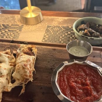 Inman Social - Cheesy garlic bread with marinara sauce and house made pesto ranch dressing. In the smaller bowl are the incredible Brussels sprouts! - Italian Near Me - Cleveland, Tennessee