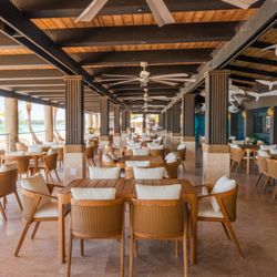 Ocean Lab Taproom - A beachfront dining area with open-air seating, ocean views, and a relaxed coastal atmosphere.