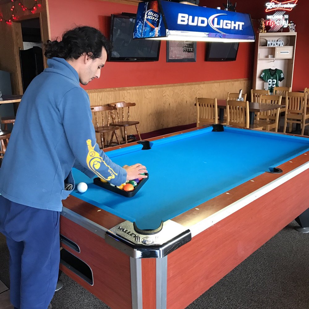 Bull Mountain Bar & Grill - a man playing pool - Bars Near Me - Tigard, Oregon Bull Mountain Bar & Grill - a man playing pool - Bars Near Me - Tigard, Oregon