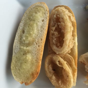 Tapelia - They call THIS a sandwich?! More like a SADwich!!!! Soggy garlic bread and 2 sad pieces of calamari  Boooooooooo! - Spanish Near Me - Miami Beach, Florida