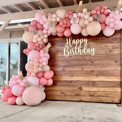 Partynista Events - Simple birthday setup with wood backdrop and organic balloon garland