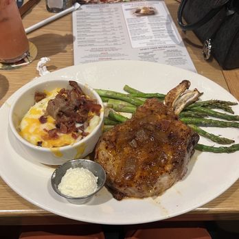 BJ's Restaurant & Brewhouse - Double Bone-In Pork Chop top w/ mandarin orange-glaze+bacon onion jam, (sides) White Cheddar Mashed Potatoes loaded and Asparagus - Breweries Near Me - Oklahoma City, Oklahoma BJ's Restaurant & Brewhouse - Double Bone-In Pork Chop top w/ mandarin orange-glaze+bacon onion jam, (sides) White Cheddar Mashed Potatoes loaded and Asparagus - Breweries Near Me - Oklahoma City, Oklahoma