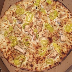 Large chicken and banana pepper pizza with a garlic sauce.