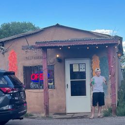 Front of restaurant with cool dudes approval.