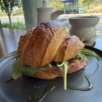 Santo Coffee - The "Roosevelt" sandwich. Turkey, prosciutto, arugula, and mustard in a croissant and drizzled with honey. This was delicious. - Coffee & Tea Near Me - Seattle, Washington Santo Coffee - The "Roosevelt" sandwich. Turkey, prosciutto, arugula, and mustard in a croissant and drizzled with honey. This was delicious. - Coffee & Tea Near Me - Seattle, Washington