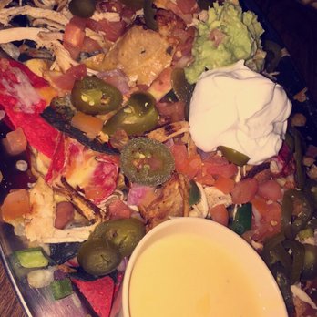 Saddle Ranch - Nachos with grilled chicken, guac and xtra cheese - Steakhouses Near Me - Orange, California