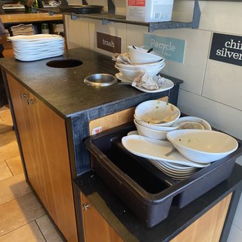 Panera Bread - Dishes piled up while workers stand around doing absolutely.  Very sad - Salad Near Me - Florence, South Carolina