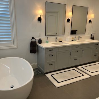 Irving Diaz Construction - a bathroom with a bathtub and two mirrors - General Contractors Near Me Irving Diaz Construction - a bathroom with a bathtub and two mirrors - General Contractors Near Me