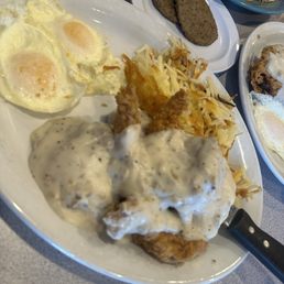 Chicken biscuits and gravy with overeasy eggs side of sausage