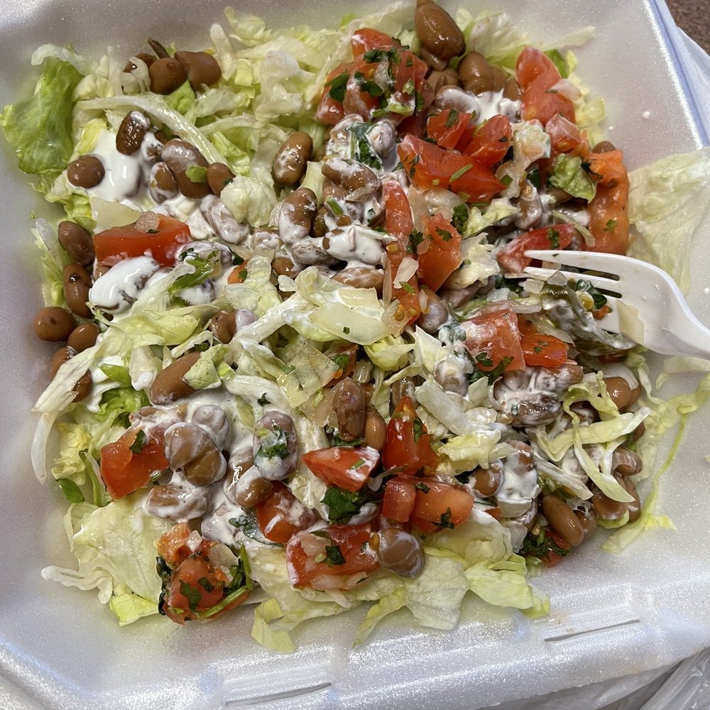 a salad in a styrofoam container