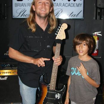 Brian Roberts Guitar Academy - Brian with one of his youngest student after his performance. - Musical Instruments & Teachers Near Me - Honolulu, Hawaii Brian Roberts Guitar Academy - Brian with one of his youngest student after his performance. - Musical Instruments & Teachers Near Me - Honolulu, Hawaii