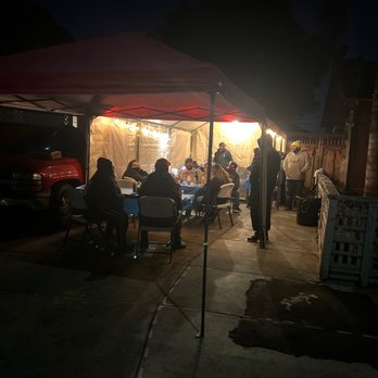 Tacos Los Primos - a group of people sitting under a tent - Tacos Near Me - San Jose, California Tacos Los Primos - a group of people sitting under a tent - Tacos Near Me - San Jose, California