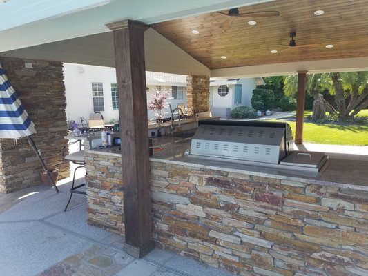 Outdoor kitchen - Built patio cover matching house profile and an outdoor kitchen to create entertainment space