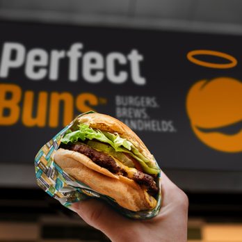 Perfect Buns - a hand holding a sandwich - Burgers Near Me - Greenville, South Carolina Perfect Buns - a hand holding a sandwich - Burgers Near Me - Greenville, South Carolina