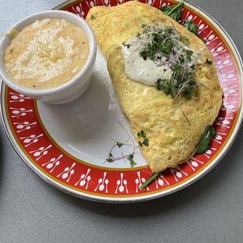 Foster's Market - Omelet with brie, ham, and spinach topped with a garlciky sauce; side of grits - Breakfast & Brunch Near Me - Durham, North Carolina